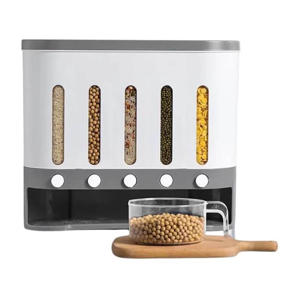The Cereal Dispenser with its 5 grids full with a white background, a plastic jar full with grains sitting on a chopping board in front.