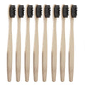 8 of the black bamboo toothbrushes positioned vertically facing diagonally, with a white background.
