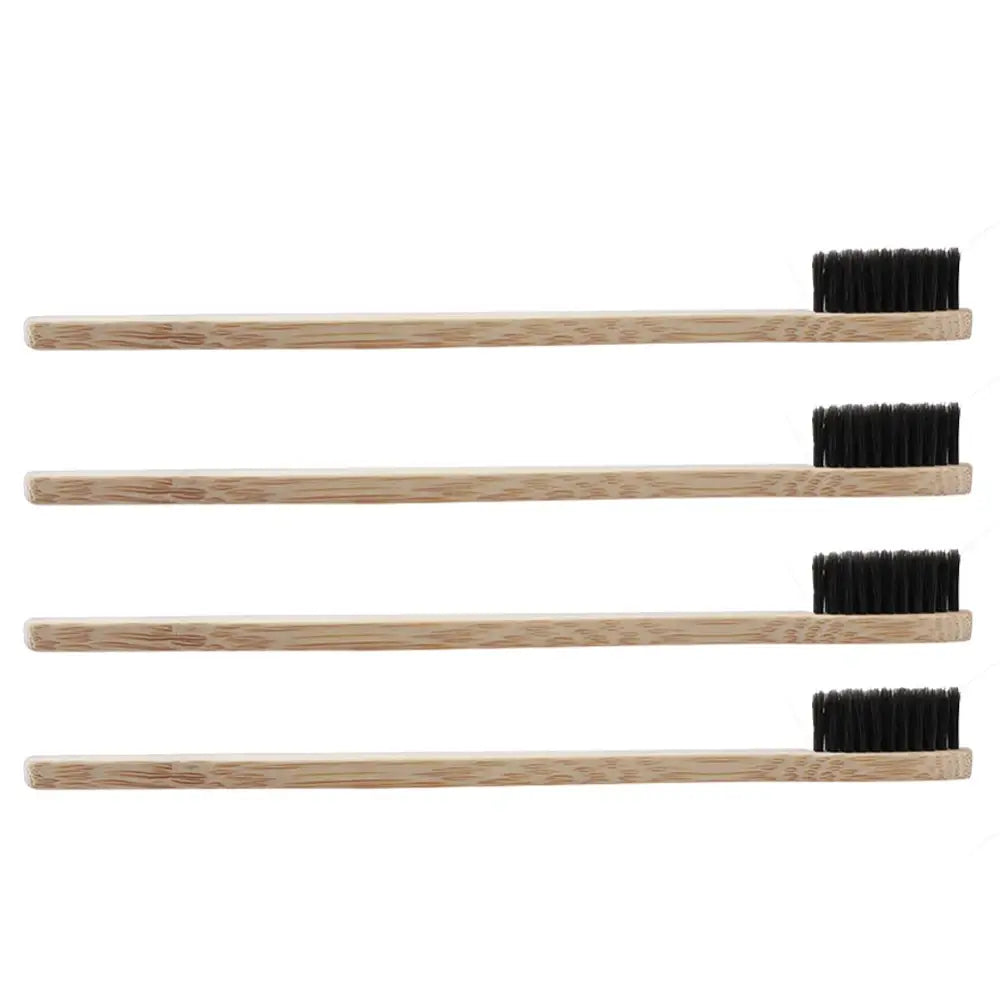 4 of the Black bamboo toothbrushes positioned horizontally facing sideways, with a white background.